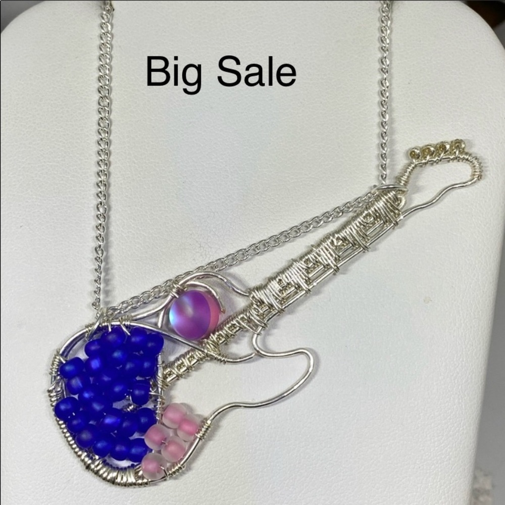 Handmade wire weaved guitar necklace.